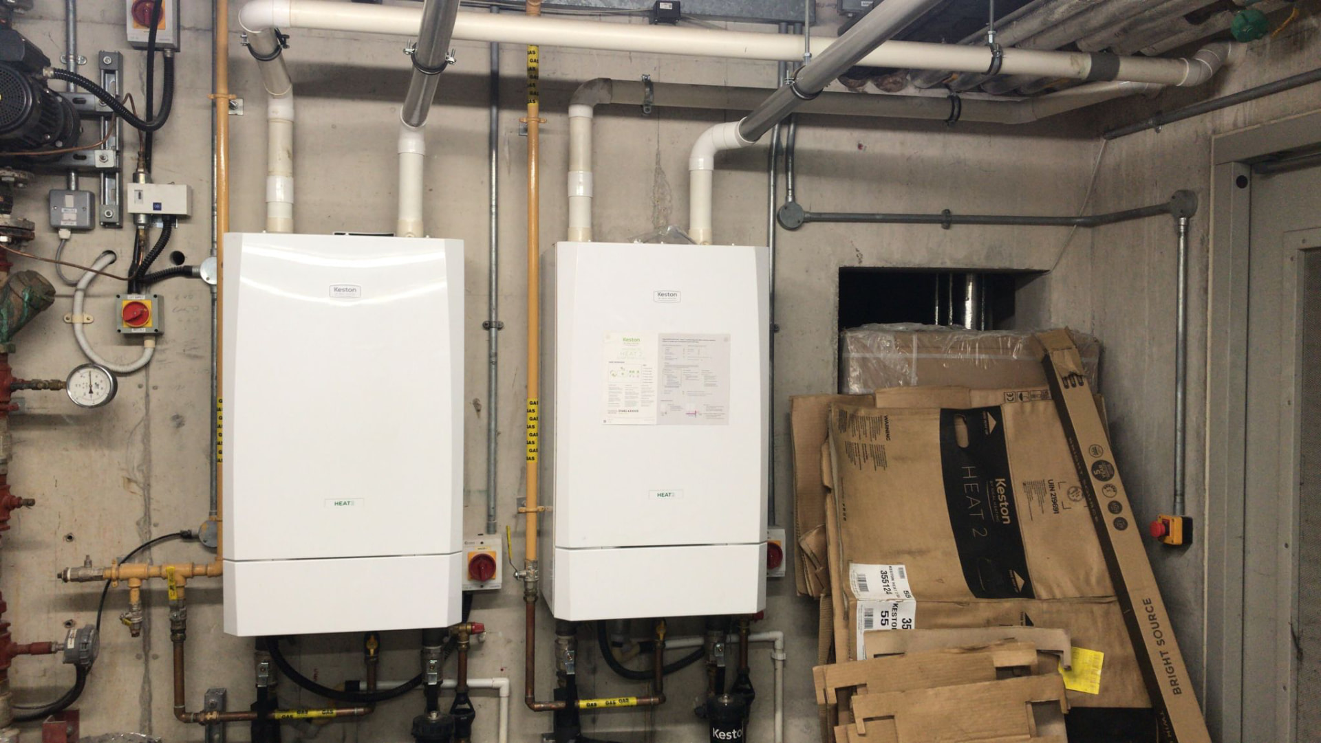 Two Keston Heat 2 boilers side by side in a basement plant room